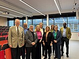 Group photo on a tour of the campus, here in the atrium of the new building